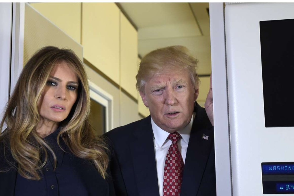 President Donald Trump and first lady Melania Trump talk with reporters on board Air Force One while traveling to Palm Beach, Fla., Friday, Feb. 10, 2017. The Trumps are hosting Japanese Prime Minister Shinzo Abe and his wife Akie Abe at their Mar-a-Lago estate in Palm Beach, Fla., for the weekend. (AP Photo/Susan Walsh)