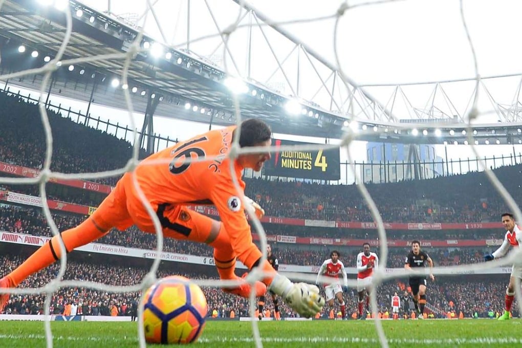 Arsenal's Chilean striker Alexis Sanchez (right) scores their second goal past Hull City's Swiss goalkeeper Eldin Jakupovic. Photo: AFP