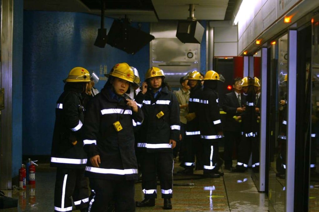 Firemen inspect a damaged MTR compartment in Admiralty station after the 2004 attack. Photo: Robert Ng