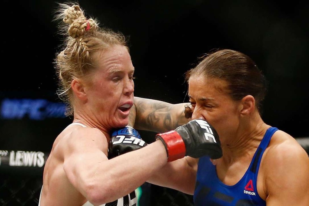 Holly Holm of United States exchanges punches with Germaine de Randamie of Netherlands in their UFC women’s featherweight championship bout at UFC 208. Photo: AFP