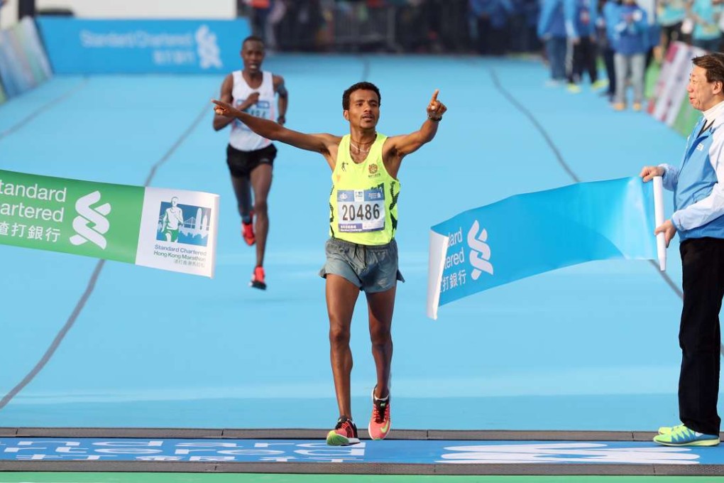 Ethiopia's Melaku Belachew takes the men's 2017 Standard Chartered Hong Kong Marathon, crossing the finish line at the Victoria Park in Causeway Bay. 12FEB17 SCMP/ Nora Tam