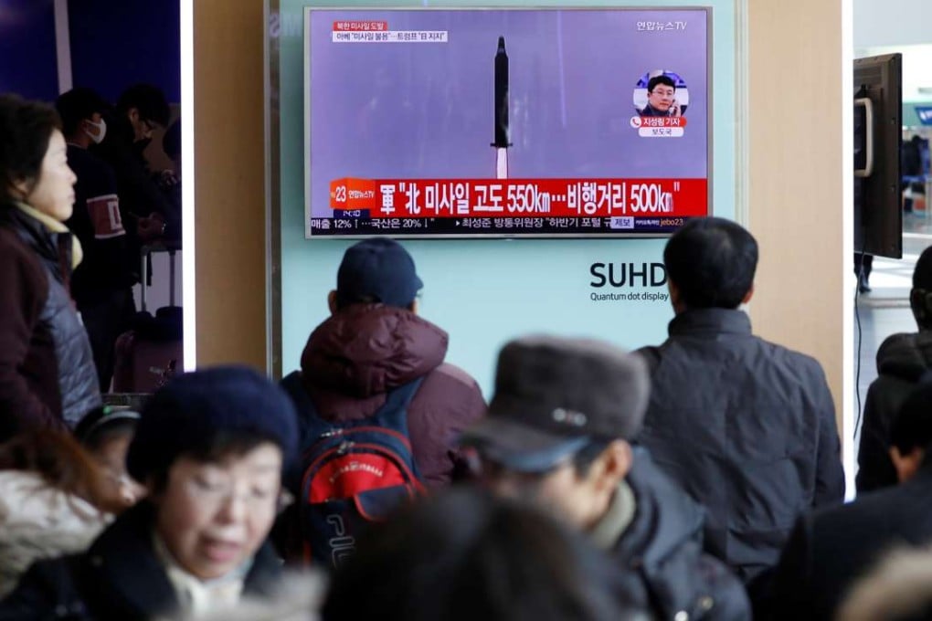 Passengers watch a TV screen broadcasting a news report on North Korea firing a ballistic missile into the sea off its east coast, at a railway station in Seoul, South Korea, on February 12. Photo: Reuters