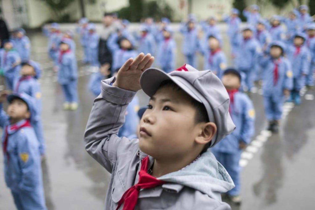 Students attending the flag-raising ceremony at the Yang Dezhi "Red Army" elementary school in Wenshui, Xishui country in Guizhou province. Photo: AFP
