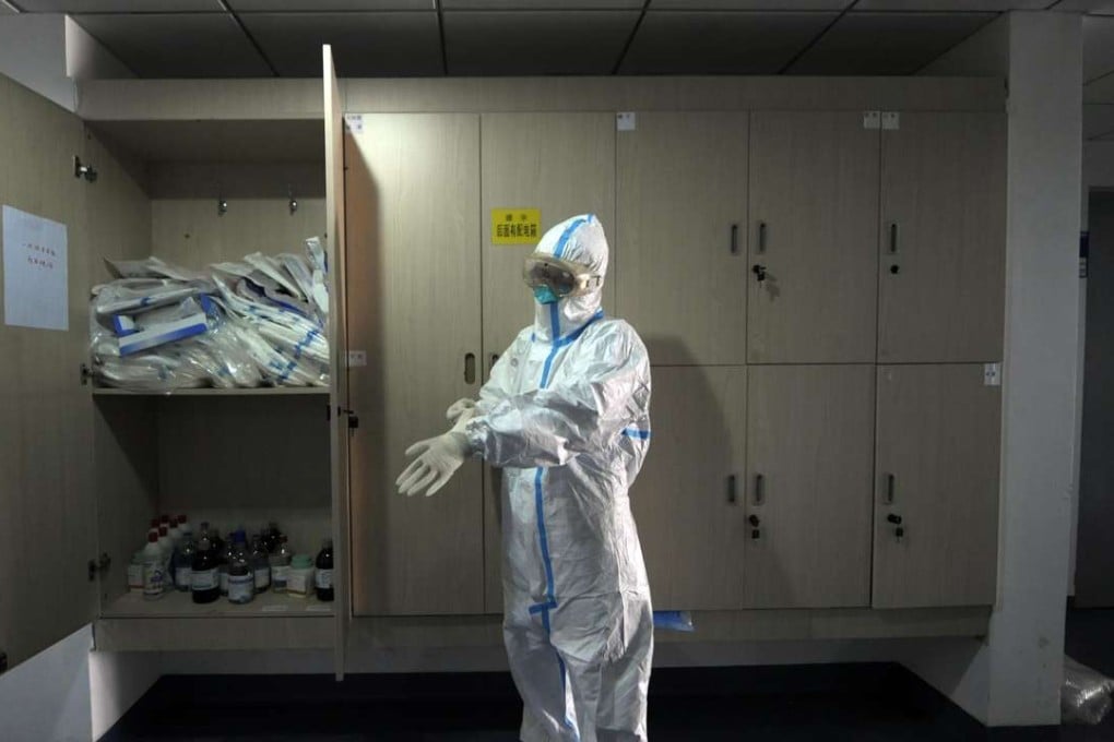 In this file photo from April 2013, a staff member with Beijing’s disease-control authority dons a protective suit. At least 130 cases of human infection have been reported across the Chinese mainland this year. Photo: AFP