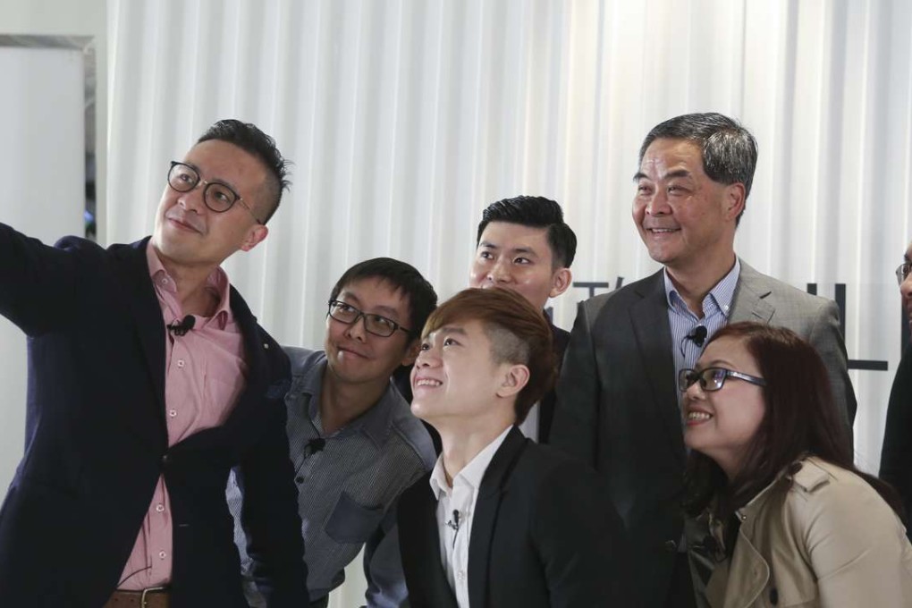 Young Hong Kong entrepreneurs take a group photo with Chief Executive Leung Chun-ying and Secretary for Innovation and Technology Nicholas Yang Wei-hsiung (right), during a Hong Kong Federation of Youth Groups web radio show at their Media 21 Media space in Aberdeen, on January 23. Photo: Sam Tsang