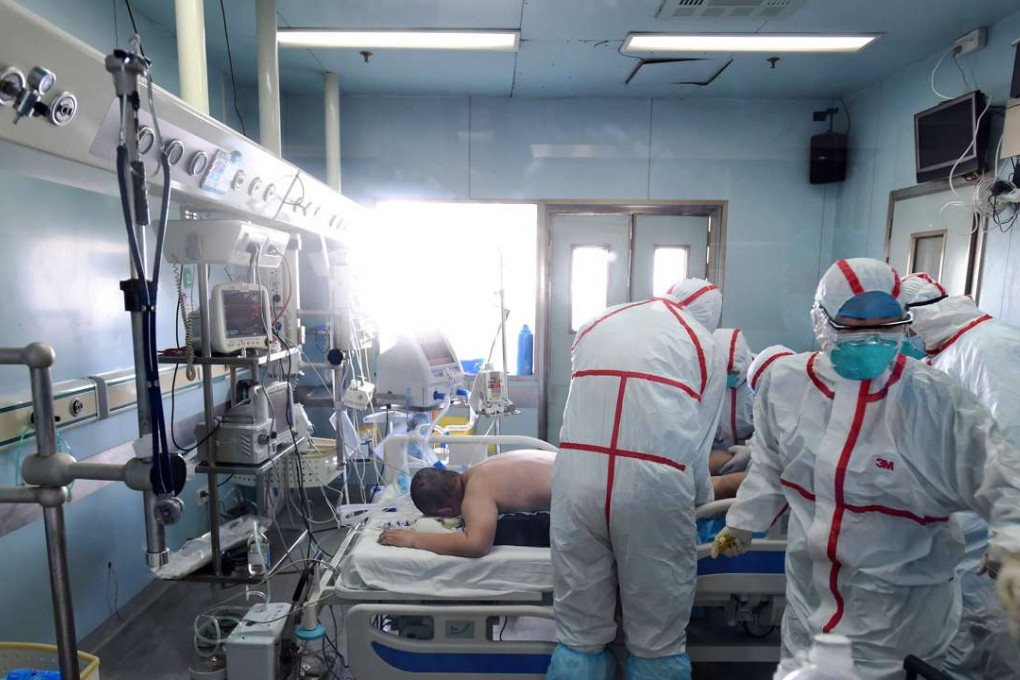 Medical workers in protective suits treat a patient with the H7N9 strain of bird flu at a hospital in Wuhan in Hubei province earlier this month. Photo: AFP