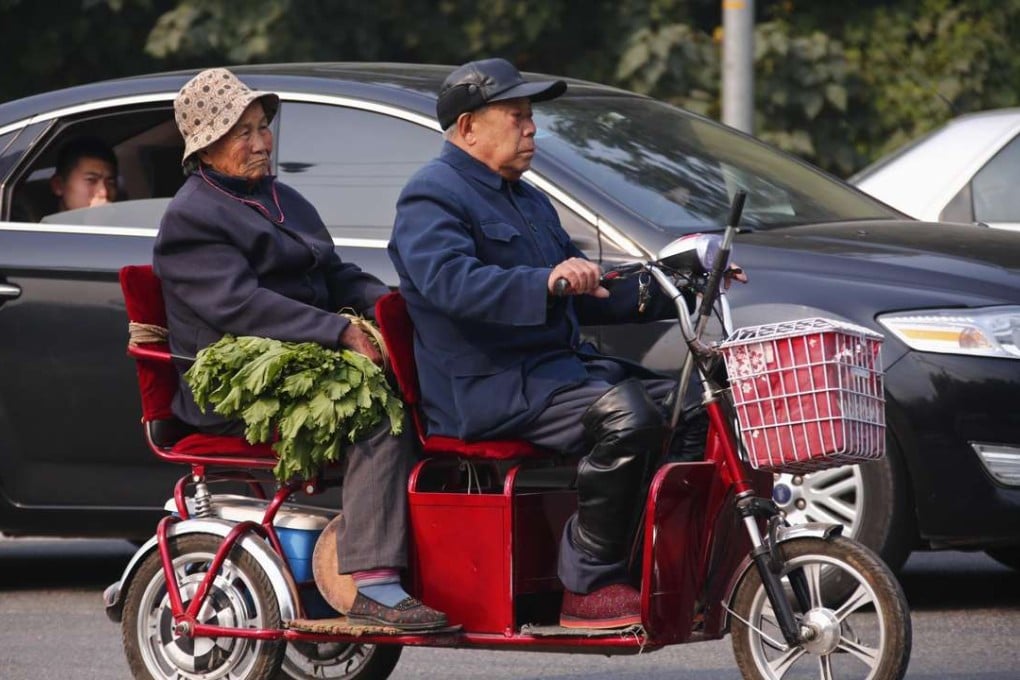 An elderly couple carrying vegetables ride a tricycle along a street in Beijing. China will be one of the fastest-ageing societies in the coming decades. Photo: Reuters