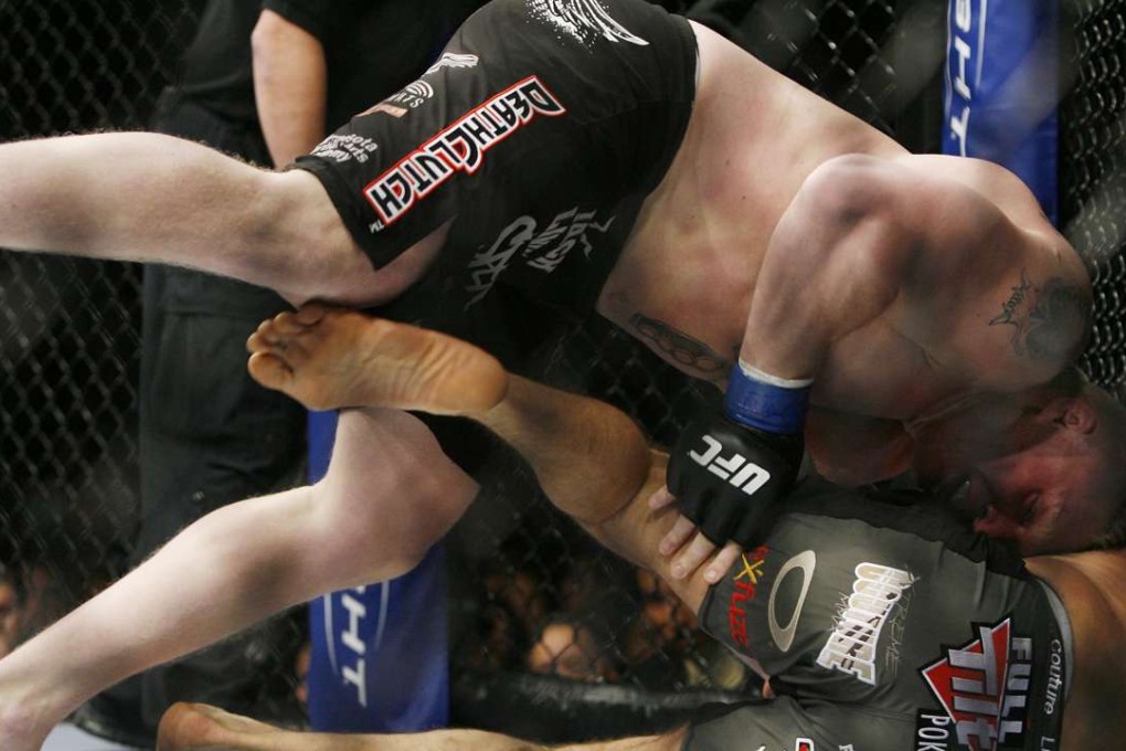 Randy Couture is taken down by Brock Lesnar during the first round of their UFC world heavyweight title match in 2008. Photo: AP