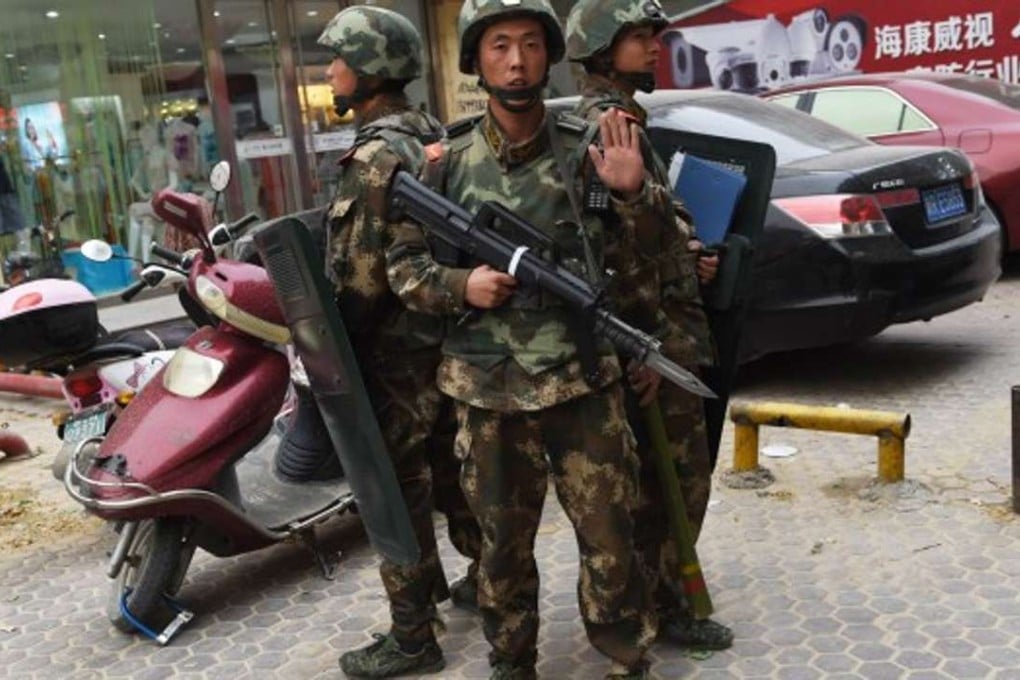 Police on patrol in Xianjiang, during a previous security crackdown on militants. Photo: AFP