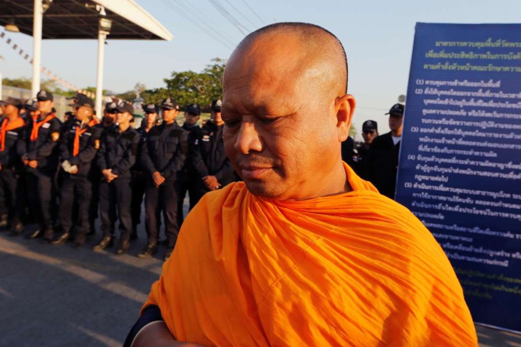 Thai police block Buddhist monks at the gate of Dhammakaya temple. Photo: Reuters