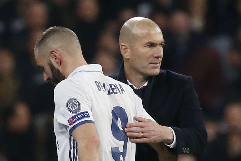 Real Madrid’s Karim Benzema is congratulated by manager Zinedine Zidane after he is substituted. Photo: Reuters