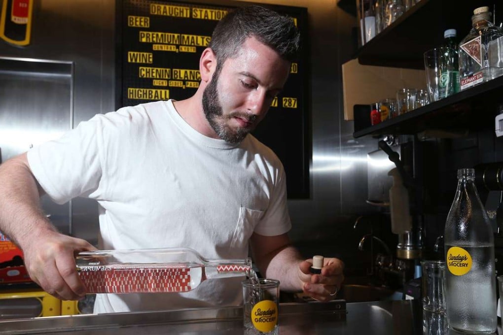 Elliot Faber – beverage director of Yardbird, Ronin and Sunday’s Grocery – pours a sake. Photo: K.Y. Cheng