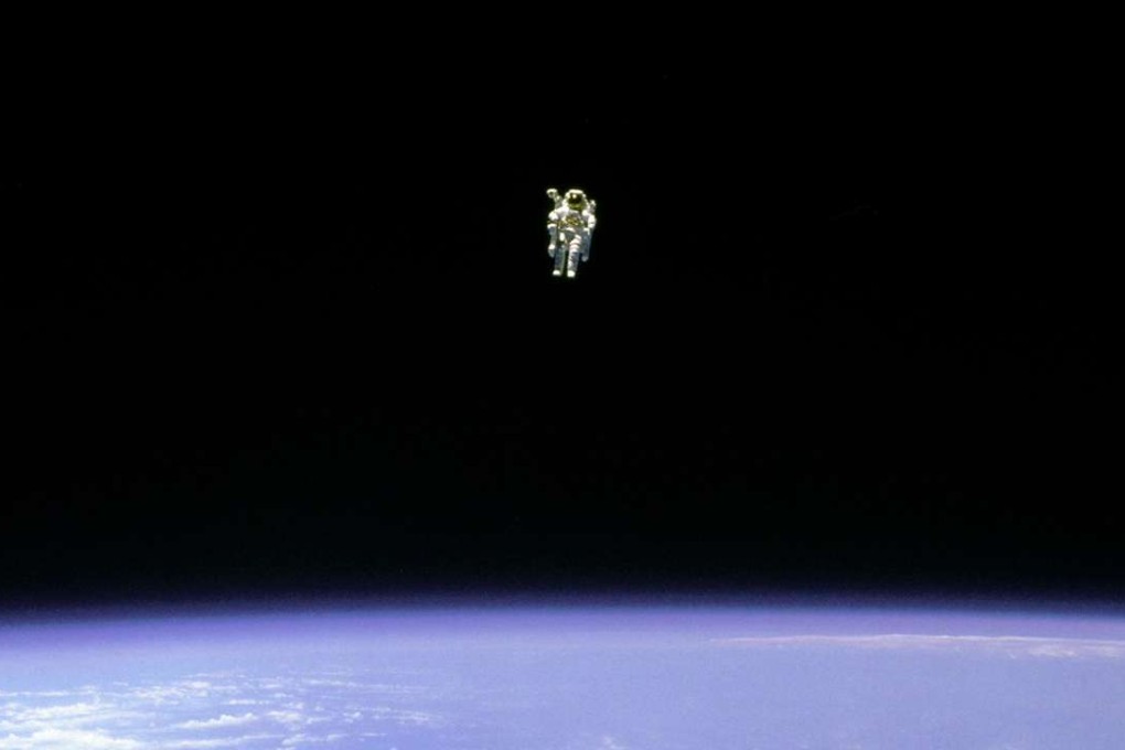 Mission Specialist Bruce McCandless II is seen on a distant spacewalk from the Space Shuttle Challenger in 1984. Photo: Reuters