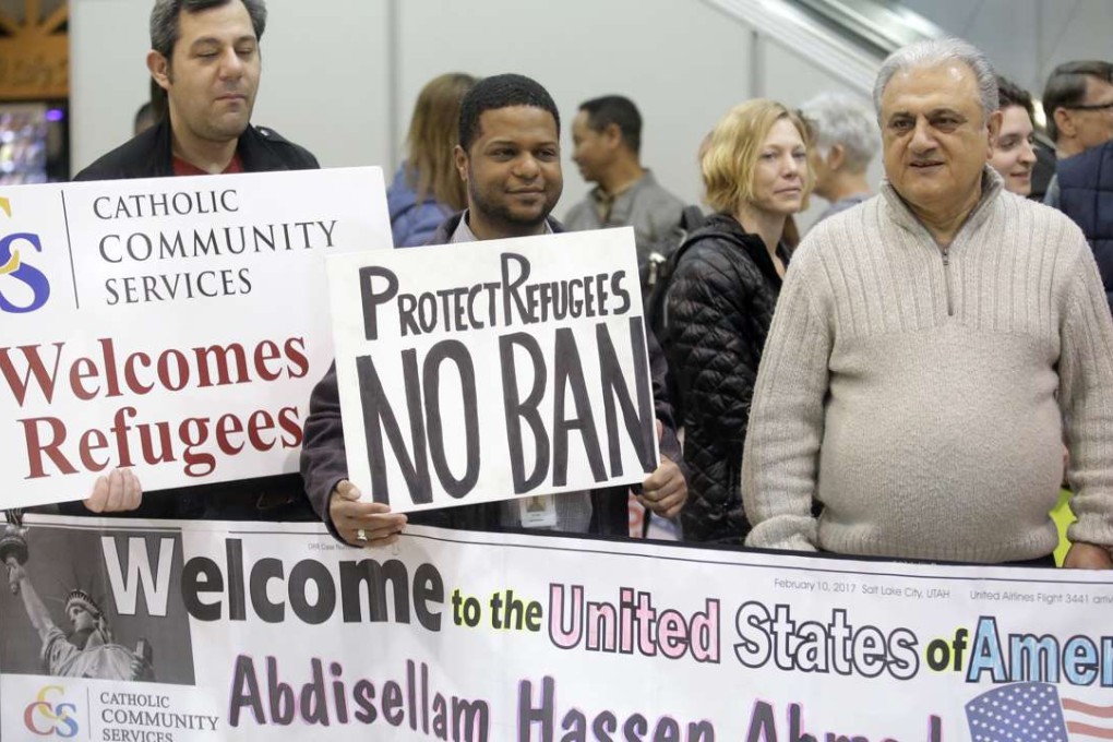 Refugee supporters look on after Abdisellam Hassen Ahmed, a Somali refugee who had been stuck in limbo after President Donald Trump temporarily banned refugee entries, arrival at Salt Lake International Airport, Friday, Feb. 10, 2017, in Salt Lake City. Photo: AP