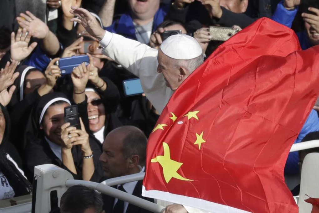 Pope Francis is framed by a Chinese flag as he greets the faithful after a Vatican mass in November. Photo: AP