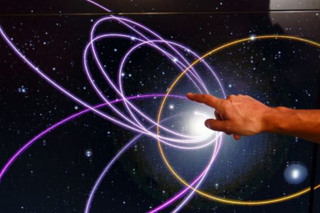 Mike Brown, professor of planetary astronomy at the California Institute of Technology, points to the gold ring showing a potential orbital path of planet nine in relation to the orbits of 'Trans-Neptunian Objects'. Photo: Patrick T. Fallon/The Washington Post