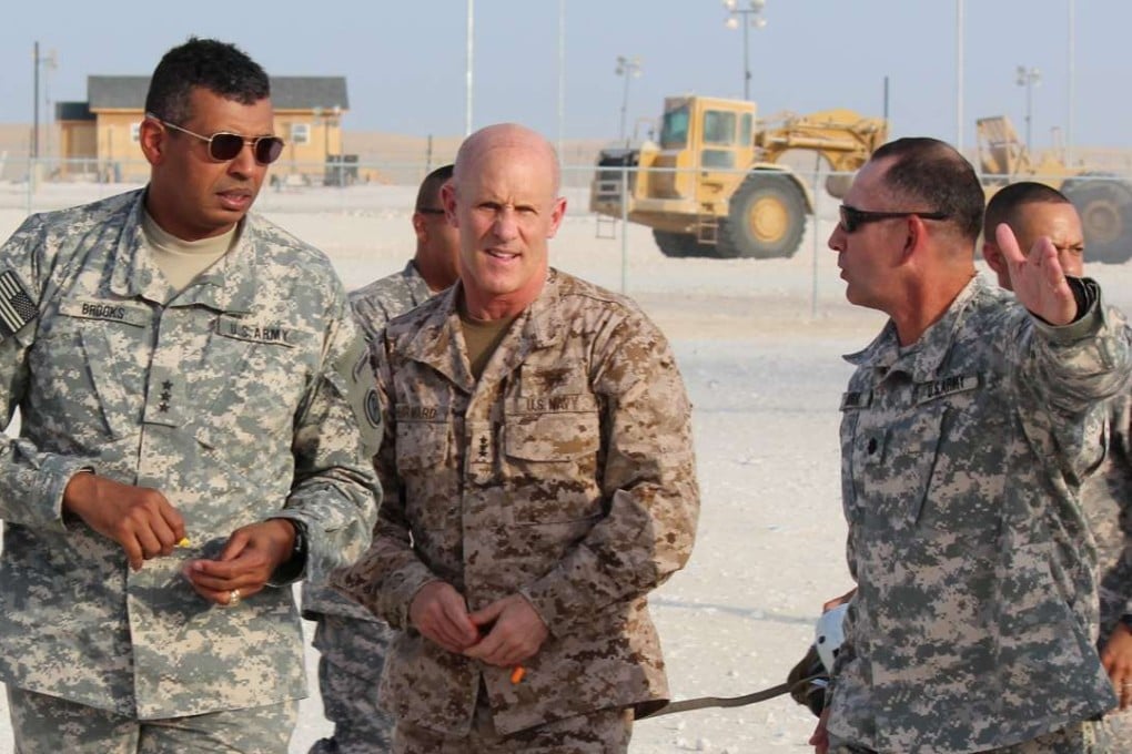 Vice-Admiral Robert Harward (centre) and Lietenant General Vincent K. Brooks (left) are greeted by Lieutenant Colonel Javier Soria at a US base in southwest Asia in 2012. Photo: Reuters