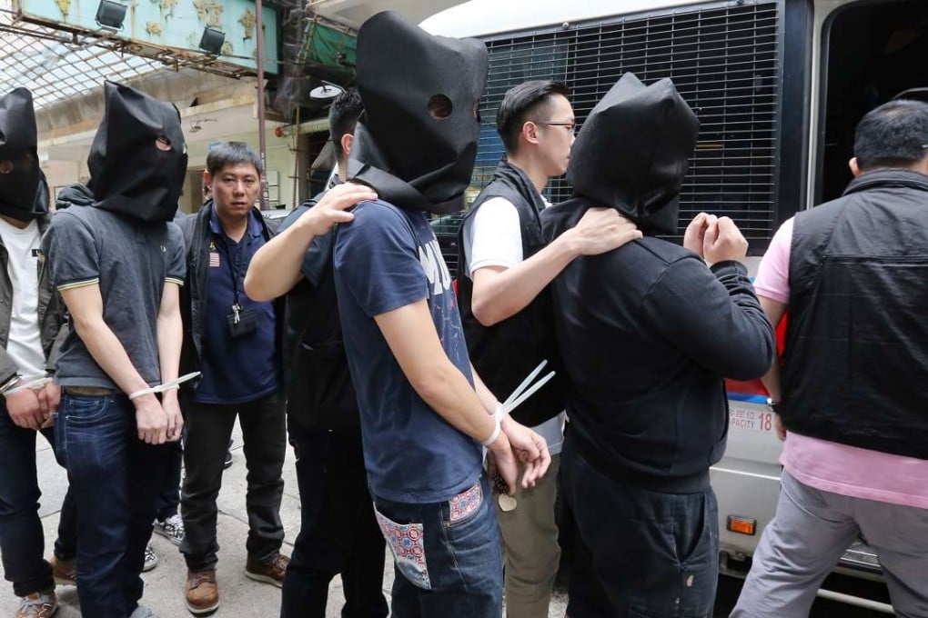 Suspected triad members are led away by police during an operation in Tsim Sha Tsui last year. Photo: Dickson Lee
