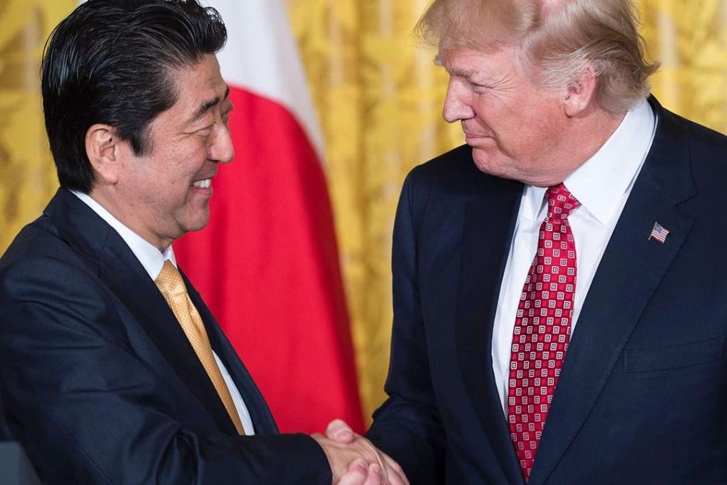 Japan's Prime Minister Shinzo Abe and US President Donald Trump shake hands after a press conference in the East Room of the White House. Photo: AFP