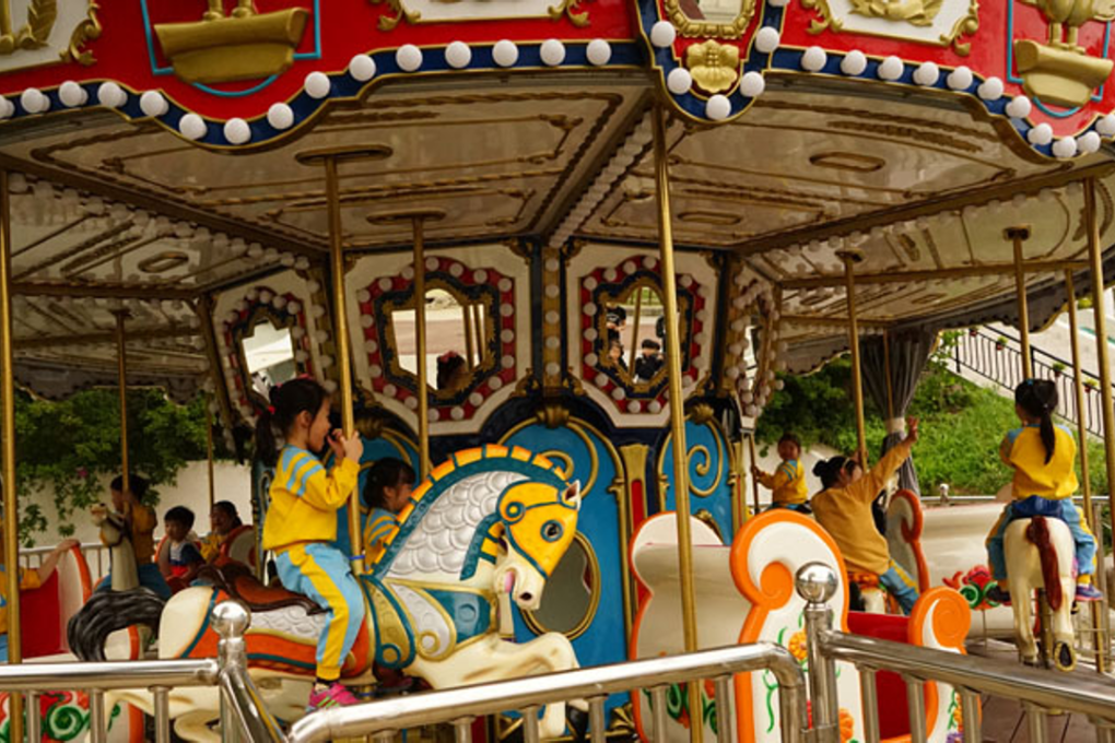 Children ride the merry-go-round after Gaya Land's reopening in 2016. Photo: Gaya Land