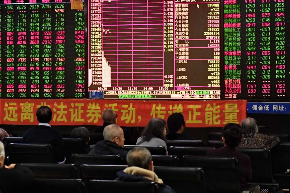 Investors look at stock information at a trading hall in Changchun, in China's Jilin Province. Photo: Xinhua