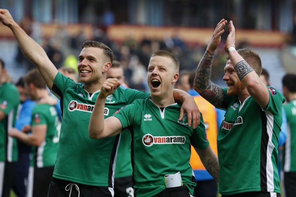 Lincoln's Alan Power, Terry Hawkridge and Jonathan Jack Muldoon celebrate after defeating Burnley. Photo: Reuters