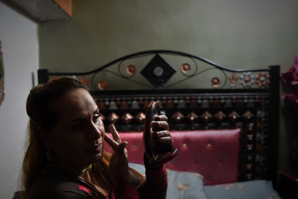 Farzana applies makeup at her home in Peshawar. Photo: AFP