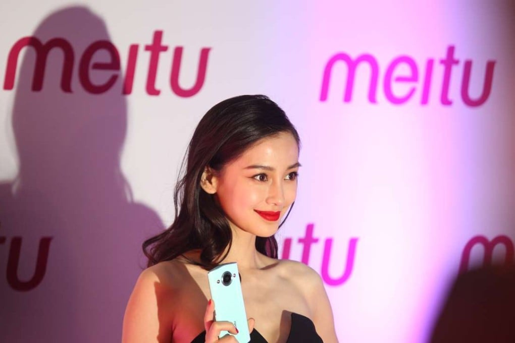 Angelababy, a well-known model and actress, poses with a new Meitu M4 phone. Photo: SCMP