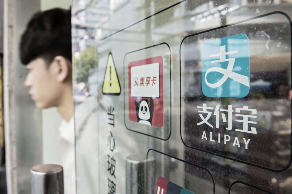Signage for Ant Financial’s Alipay payment system is displayed on a store entrance in Shanghai. Photo: Bloomberg