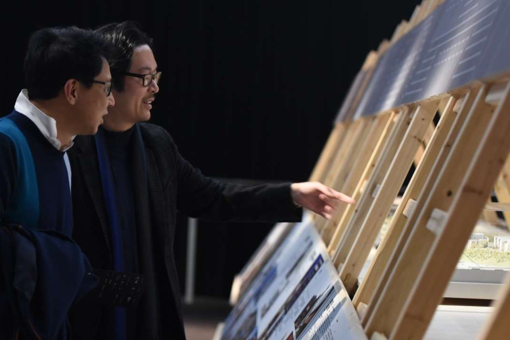 Visitors looking at the 10x100 exhibition in PMQ.