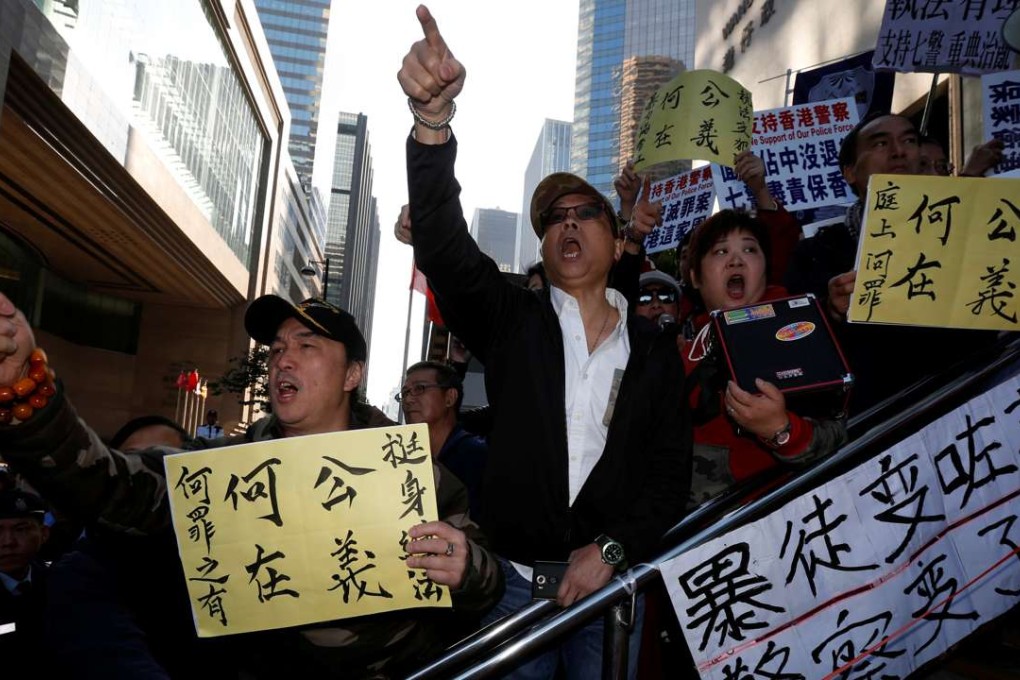 Supporters of police officers argue with pro-democracy protesters outside a court where seven police officers were convicted of kicking and punching activist Ken Tsang during an Occupy protest more than two years ago. Photo: Reuters