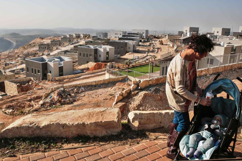 An Israeli woman gets ready to feed her baby earlier this month near a construction site in a new housing project in the Israeli settlement of Na’ale, near the West Bank city of Ramallah. The Arab world and the Palestinians fear Trump giving unwarranted attention to one-state “peace plans” from the Israeli right, which would be totally unacceptable to the Palestinians. Photo: AFP