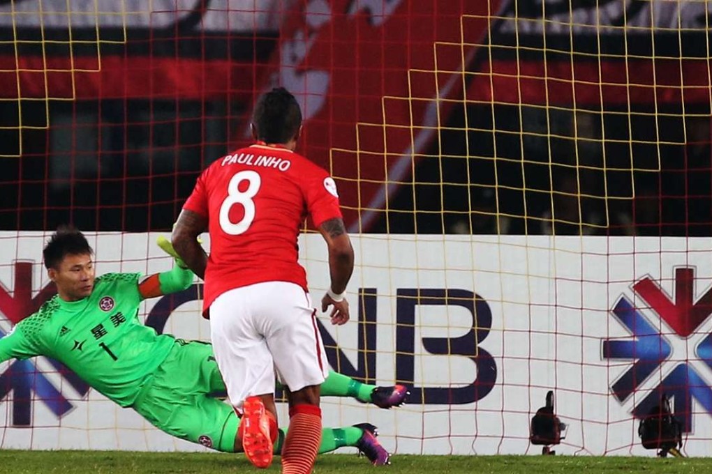 Guangzhou Evergrande’s Paulinho scores against Eastern goalkeeper Yapp Hung-fai. Photo: K. Y. Cheng