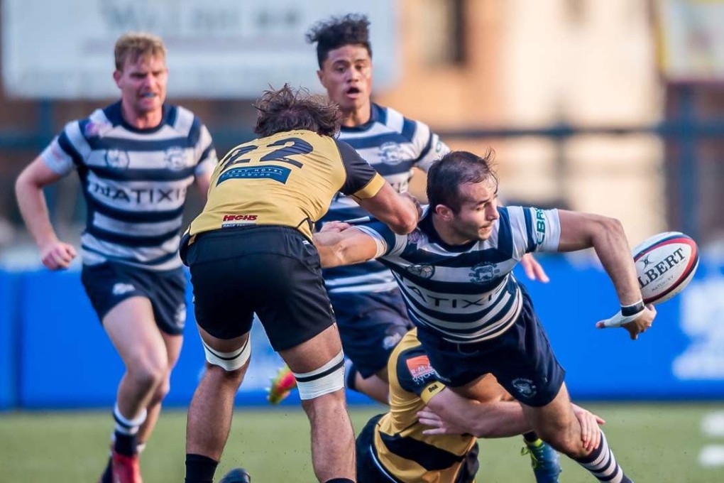 Football Club winger Seb Alfonsi offloads in the tackle against Tigers in the Hong Kong Premiership. Photo: HKRU
