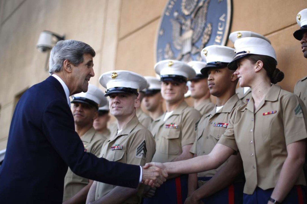 Fromer U.S. Secretary of State John Kerry shakes hands with US Marines based in Baghdad. Photo: AFP