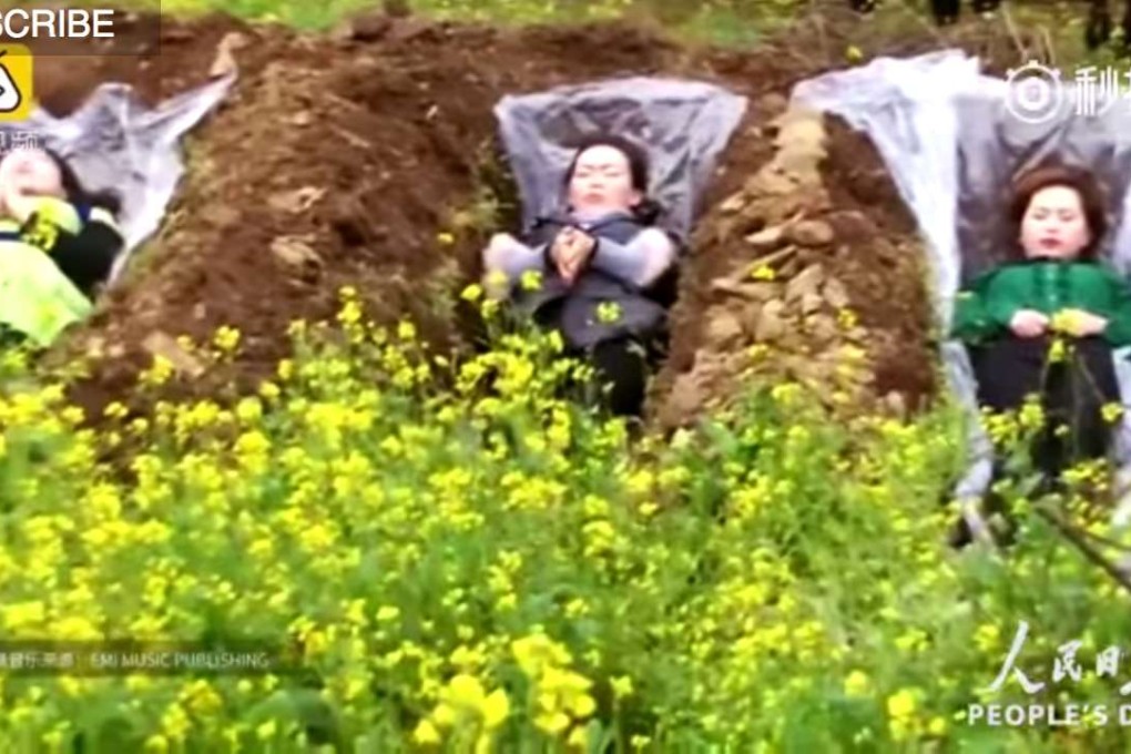 Participants contemplate the meaning of life, inside a mock grave. Photo: Handout