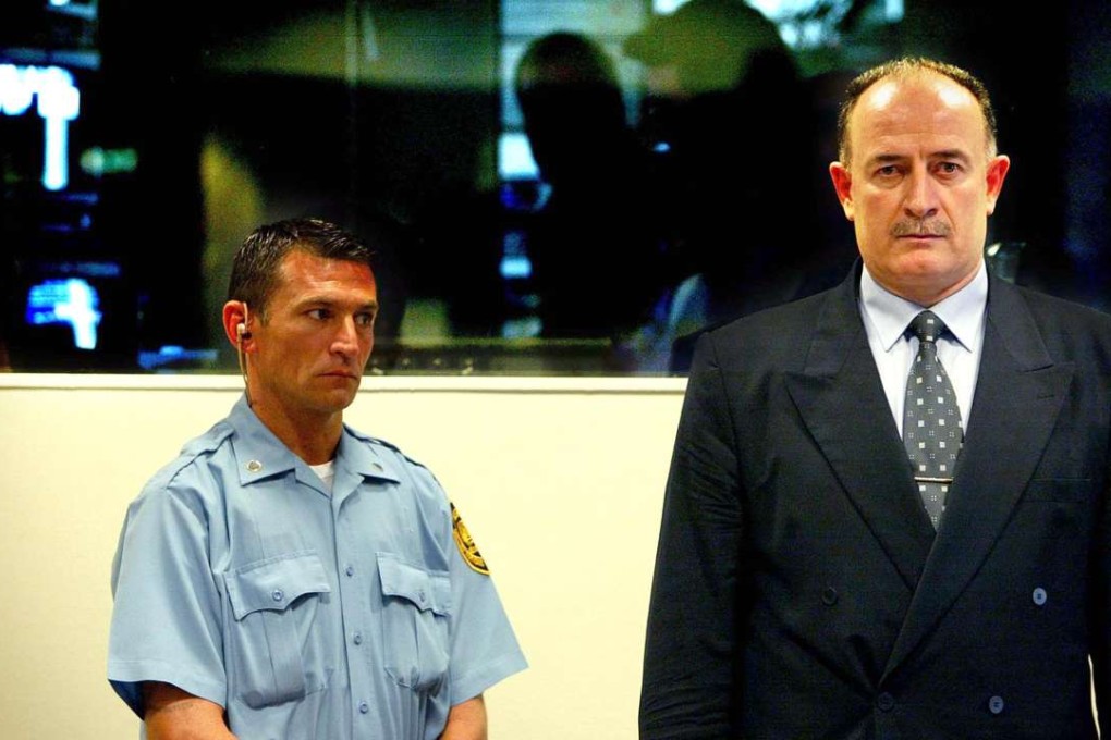 This file photo taken on July 10, 2003 at the war crimes tribunal in The Hague shows Veselin Sljivancanin (right), a former Yugoslav army officer. He spent more than six years in jail over the 1991 massacre of some 260 people in the Croatian town of Vukovar. Photo: AFP