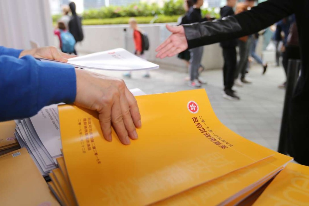 Staff of government handing out leaflets of budget 2017 - 2018 to public at Central Government Offices in Tamar. Photo: Xiaomei Chen