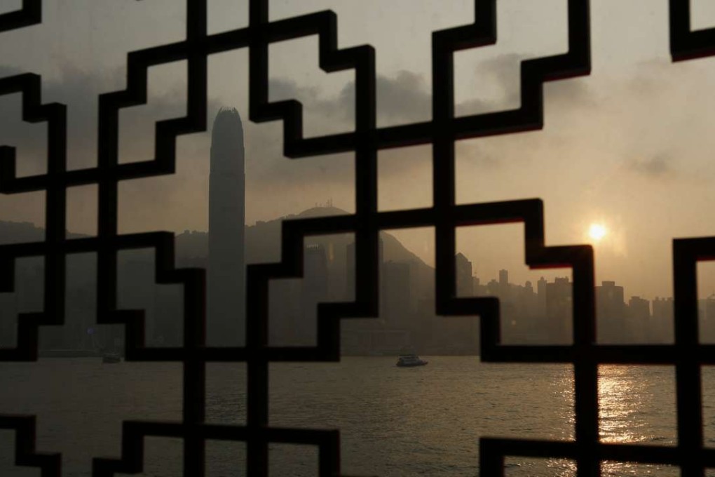 Hong Kong’s financial district, shrouded in smog, is seen through Lunar New Year decorations in 2015. Photo: Reuters