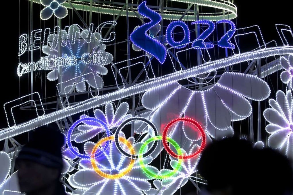 People walk past a lighted display for the upcoming 2022 Beijing Winter Olympics during an event celebrating the Lantern Festival at a park in Beijing. The next three Olympics are in Asia – Pyeongchang 2018, Tokyo 2020, and Beijing 2022. Photo: AP