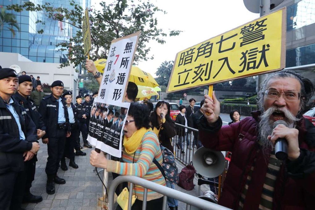 Activist Ken Tsang Kin-chiu's supporters hold a protest banner outside the District Court. Seven policemen are found guilty of beating up activist Ken Tsang Kin-chiu who had assaulted their colleagues during Occupy Central protest. Photo: Edward Wong