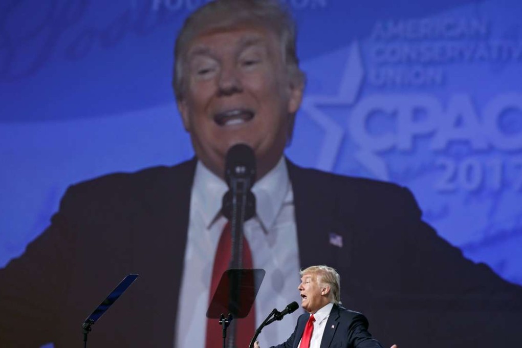 With his image projected upon a huge screen, US President Donald Trump speaks at the Conservative Political Action Conference, or CPAC, in Oxon Hill, Maryland. Photo: Reuters