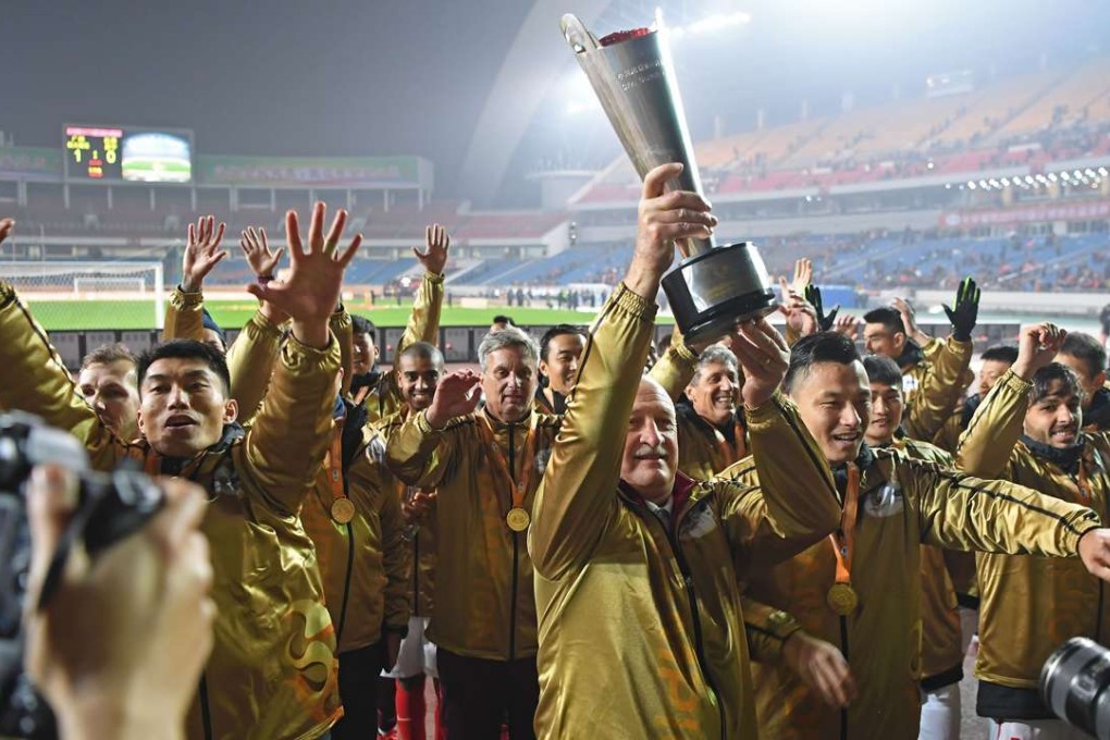 Luiz Felipe Scolari lifts the trophy. Photo: Xinhua