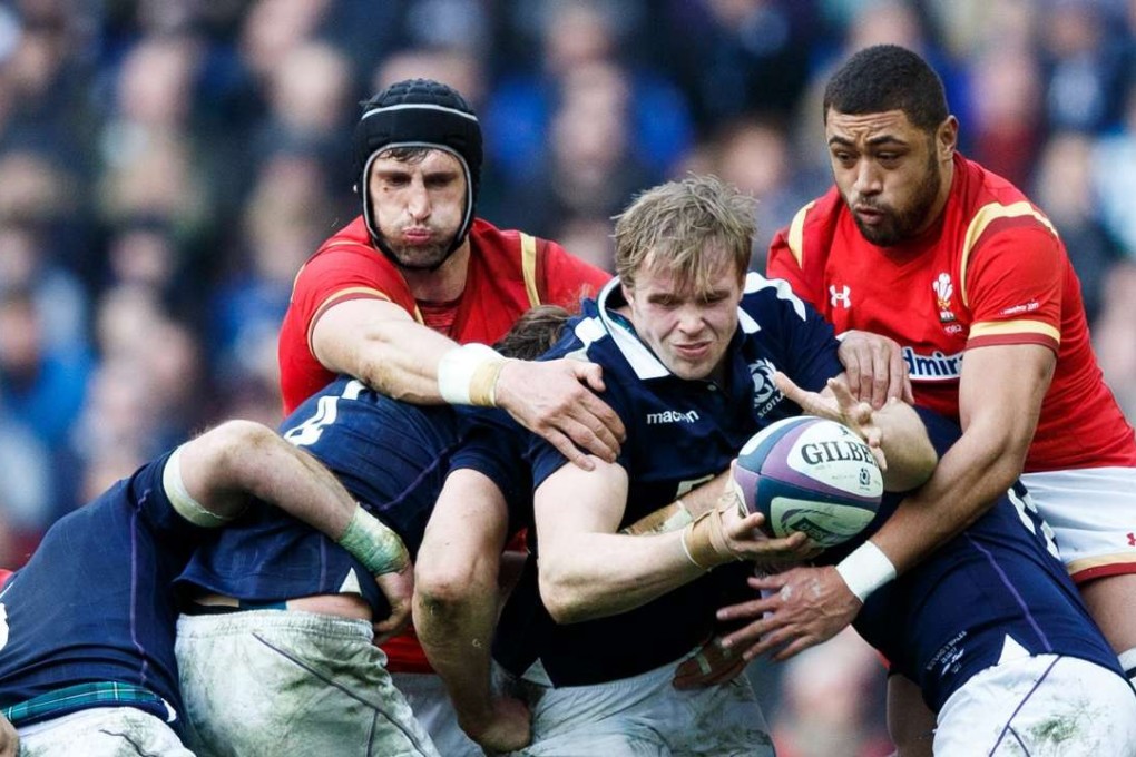 Jonny Gray (C) of Scotland wins the ball from Luke Charteris (L) anfd Taulupe Faletau (R) of Wales. EPA/ROBERT PERRY