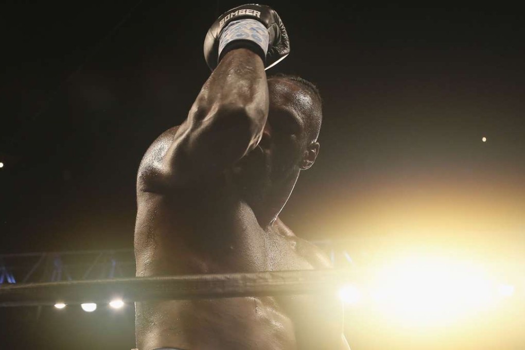 Deontay Wilder celebrates after knocking out Gerald Washington. Photo: AFP