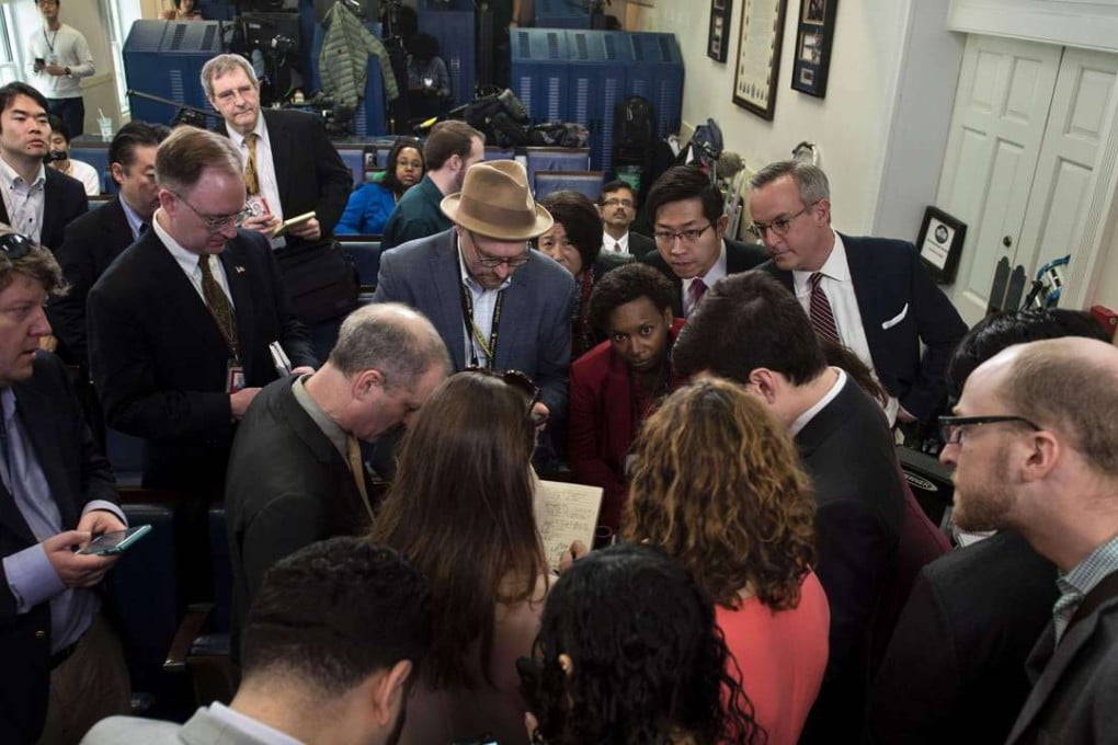 Reporters talk after failing to get access to an off camera briefing with White House Press Secretary Sean Spicer and a small group of reporters instead of the normal on camera briefing at the White House. Photo: AFP