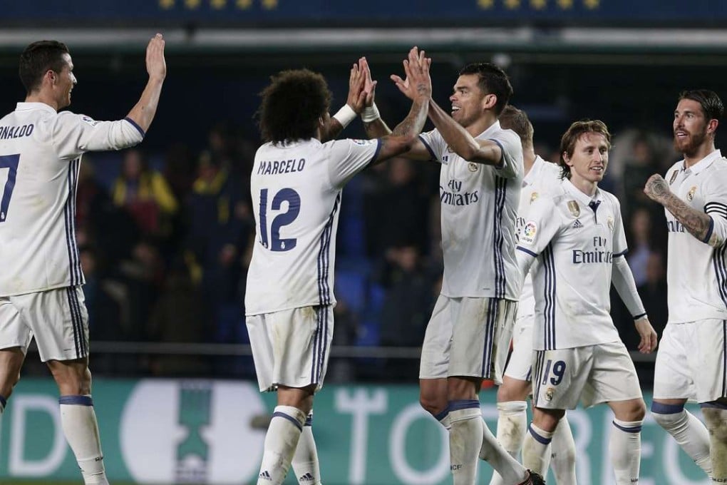 Real Madrid players celebrate after defeating Villarreal in a hard-fought 3-2 victory. Photo: EPA