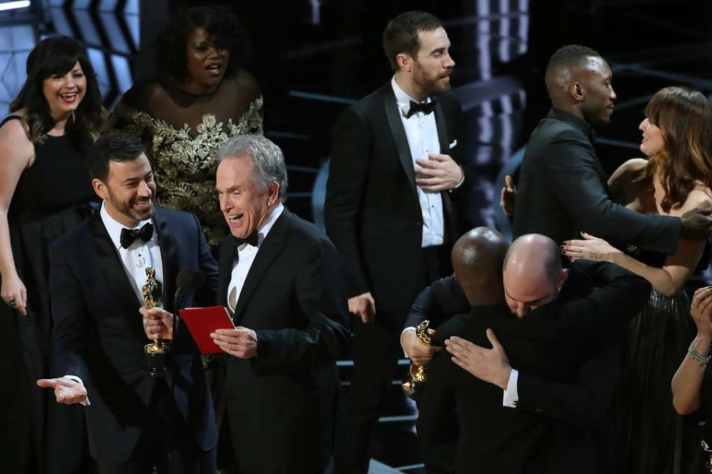Jimmy Kimmel and Warren Beatty laugh at the Oscars while the makers of La La Land and Moonlight mingle onstage. La La Land was mistakenly announced as the winner of best picture, instead of the true winner, Moonlight. Photo: Reuters