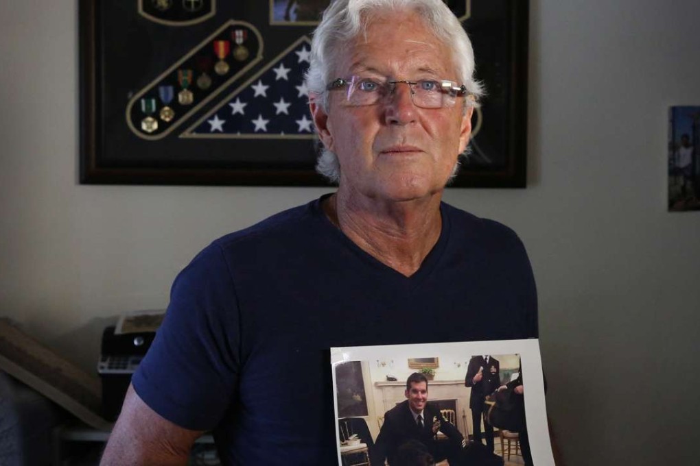 William Owens holds a photo of his youngest son, Navy SEAL William Ryan Owens in Lauderdale by the Sea, Florida. Ryan Owens was killed during an anti-terrorism raid in Yemen last month. Photo: TNS