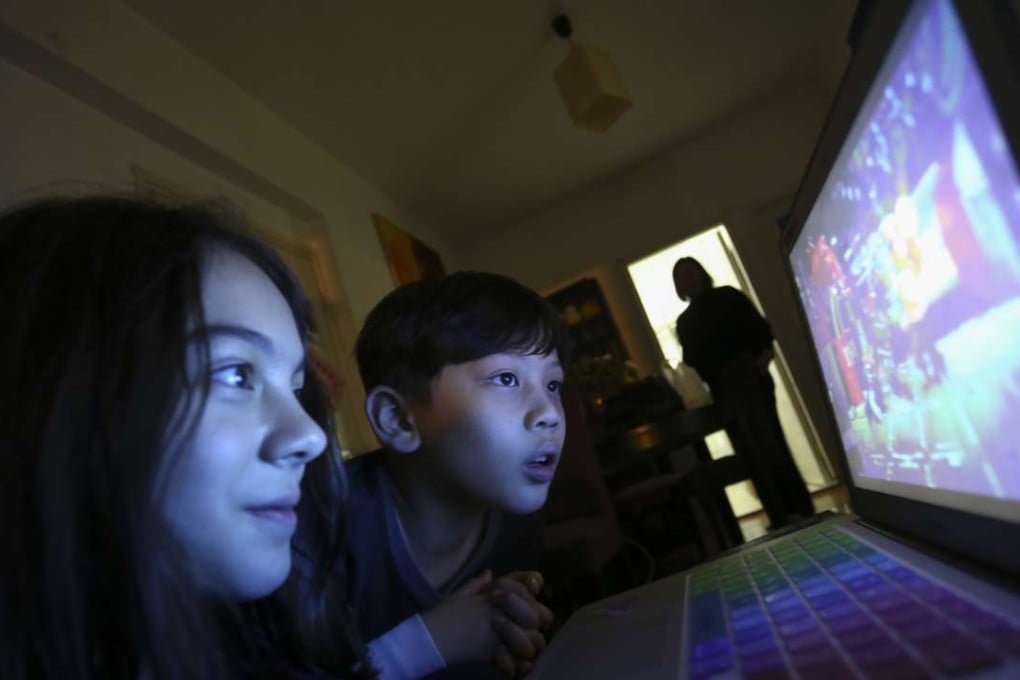Sharon Western looks on as her children Isabella (left) and Daniel look at a computer screen at their home in Happy Valley. Photo; Jonathan Wong